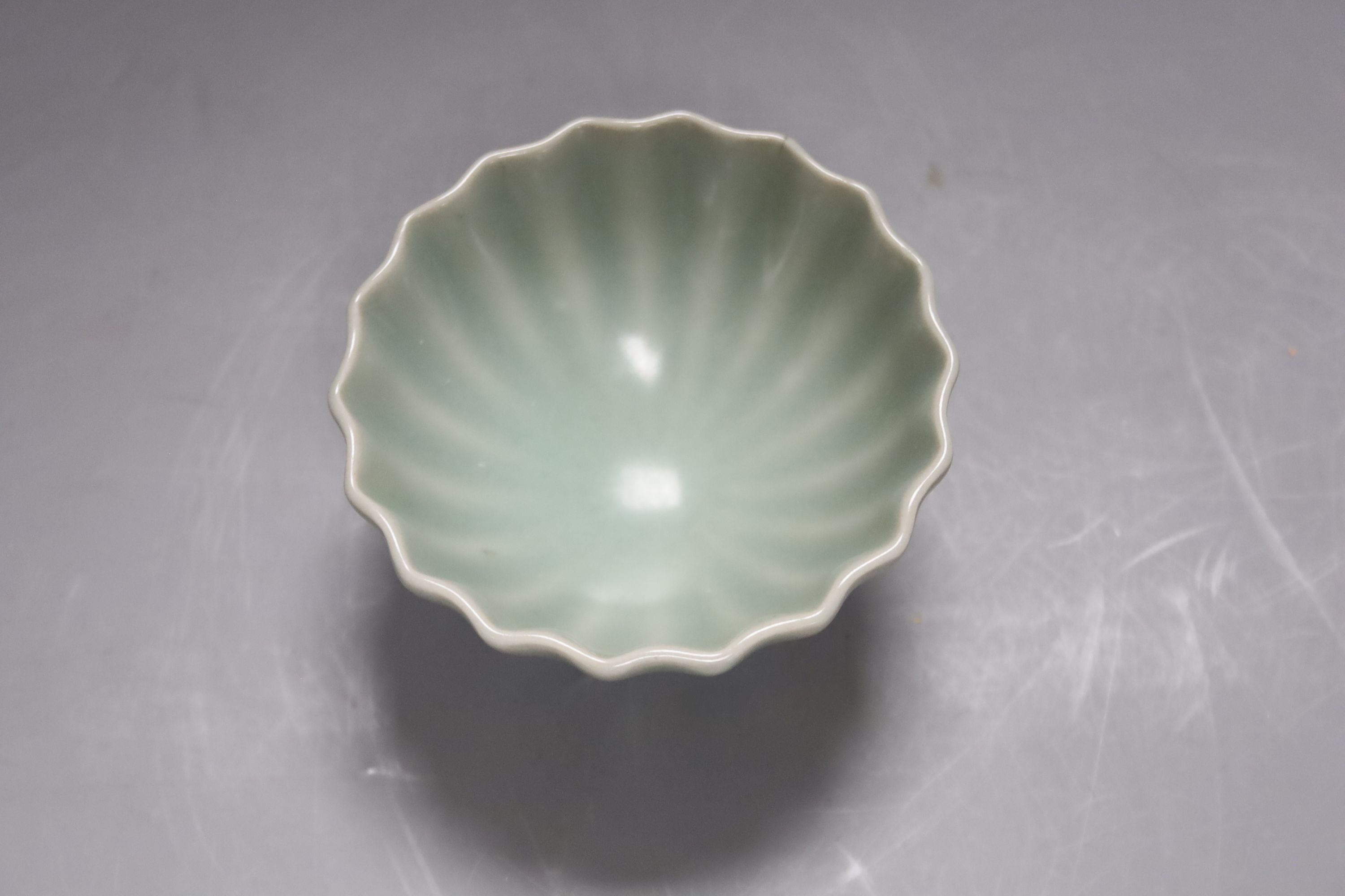 A Chinese celadon fluted cup, 9cm